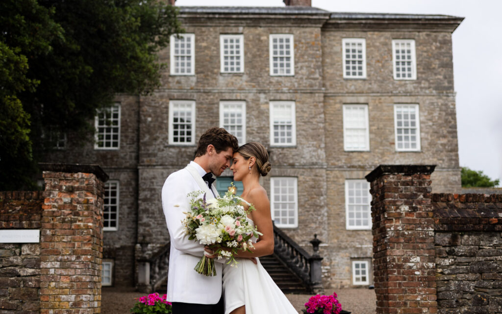 bride and groom in front of the beautiful kingston house