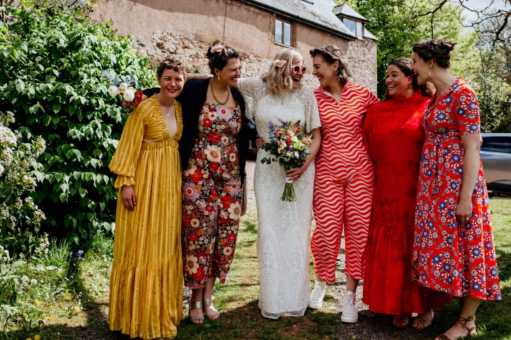 bride and bridesmaids in colourful dresses at middle coombe farm wedding