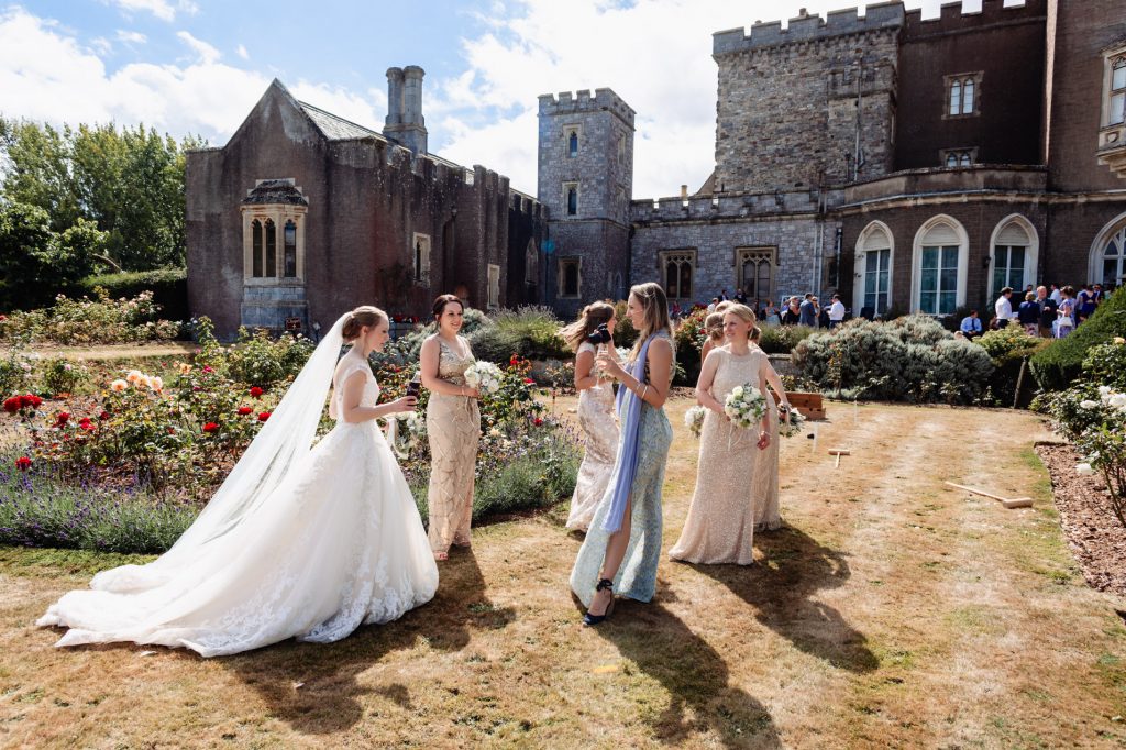 bride and bridesmaids in the garden at powderham castle
