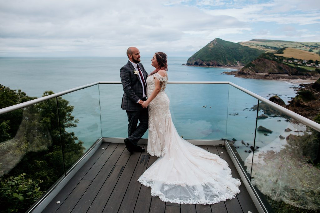 bride graoom and stunning coastal view sandy cove wedding venue