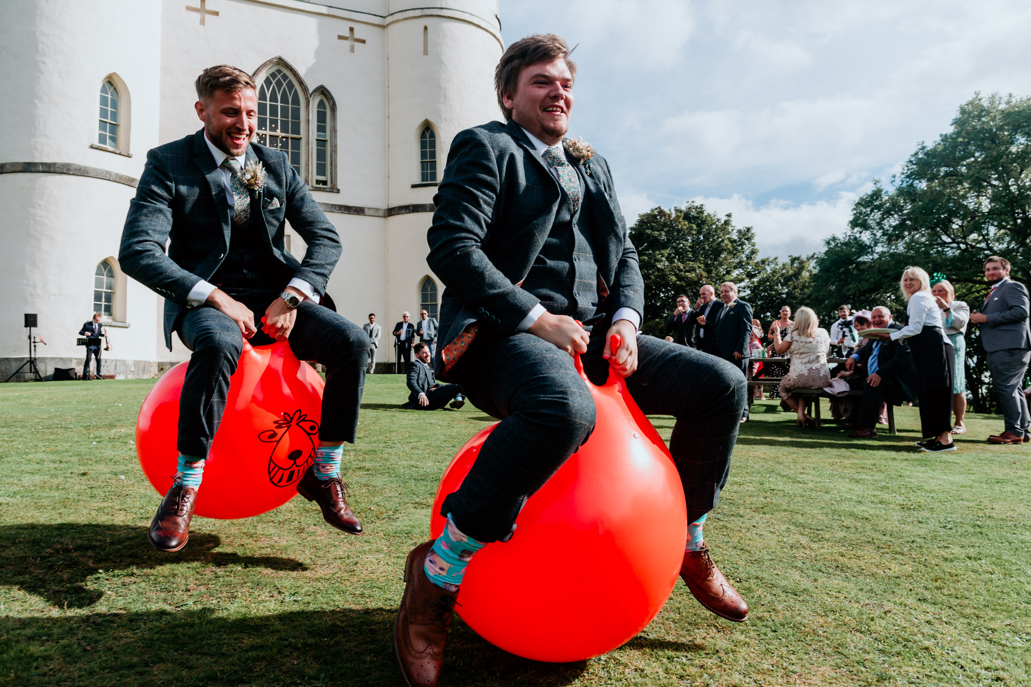 groomsmen on spacehoppers at a belvedere castle wedding exeter devon