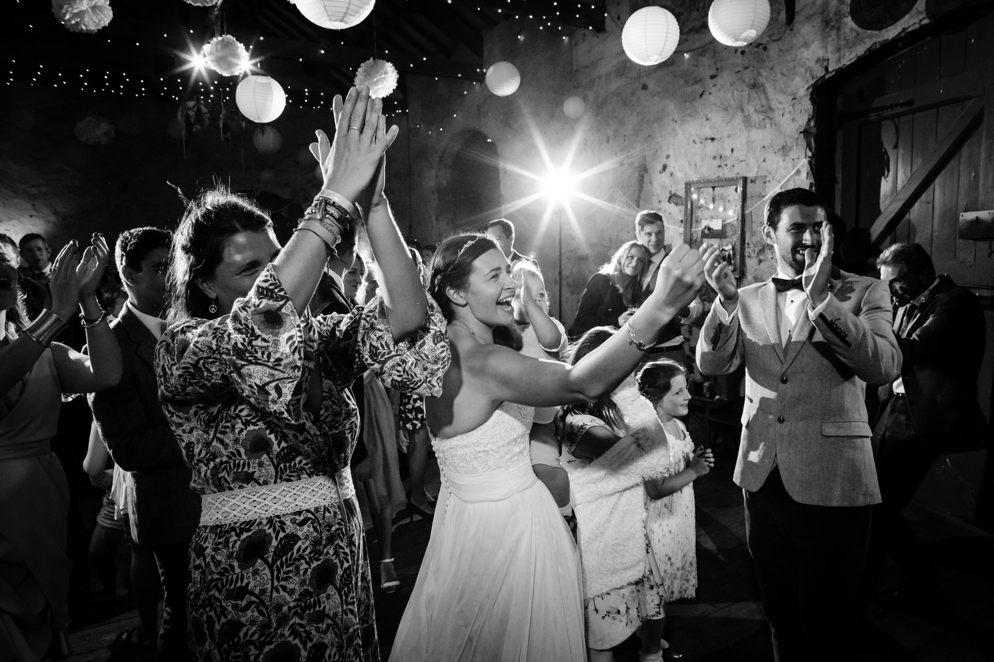 bride groom and guests applaude the ceilidh band at a wedding at bickham barn kenn near exeter devon