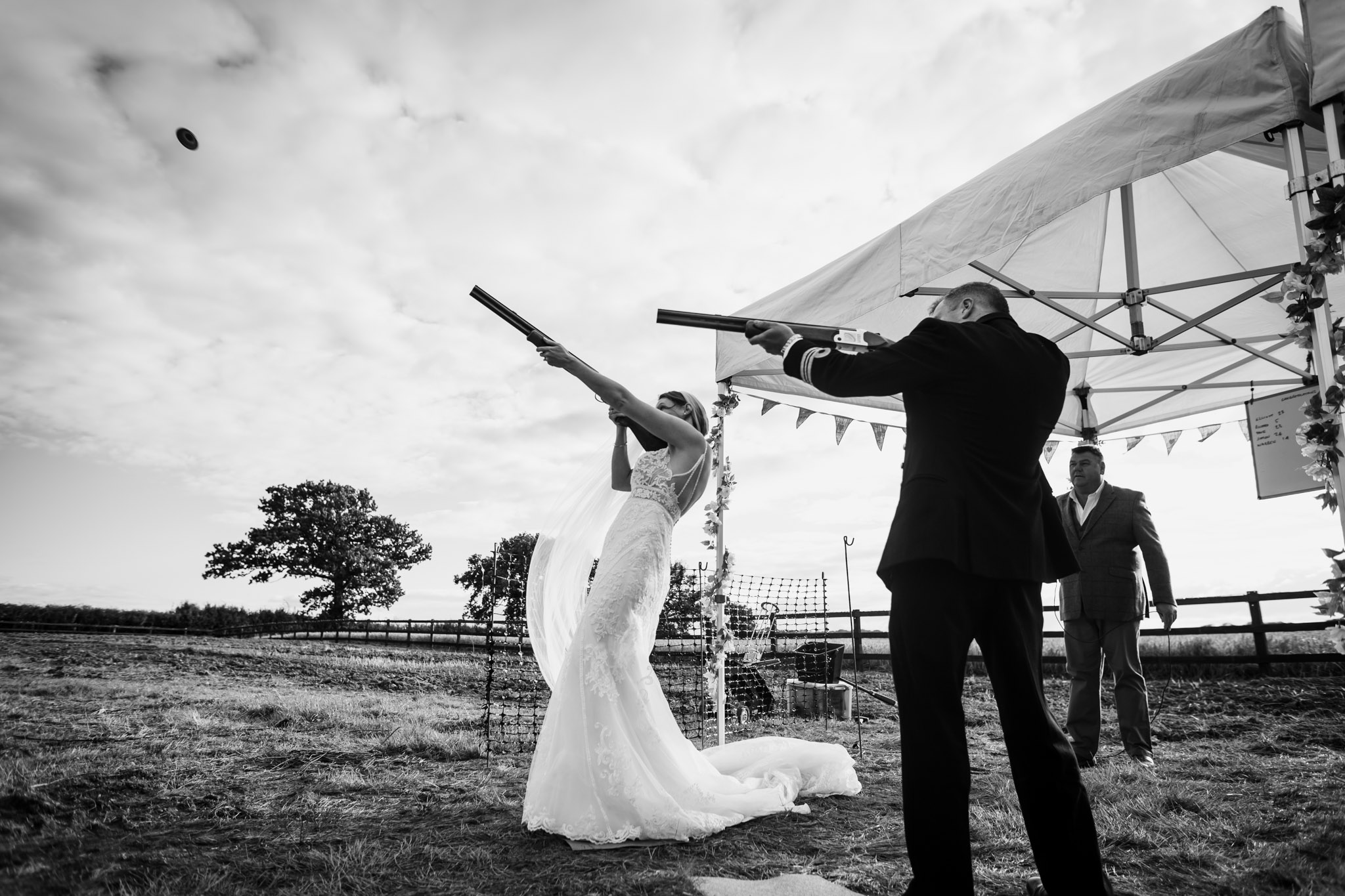 bride and groom clay pigeon shooting at crediton barn wedding devon