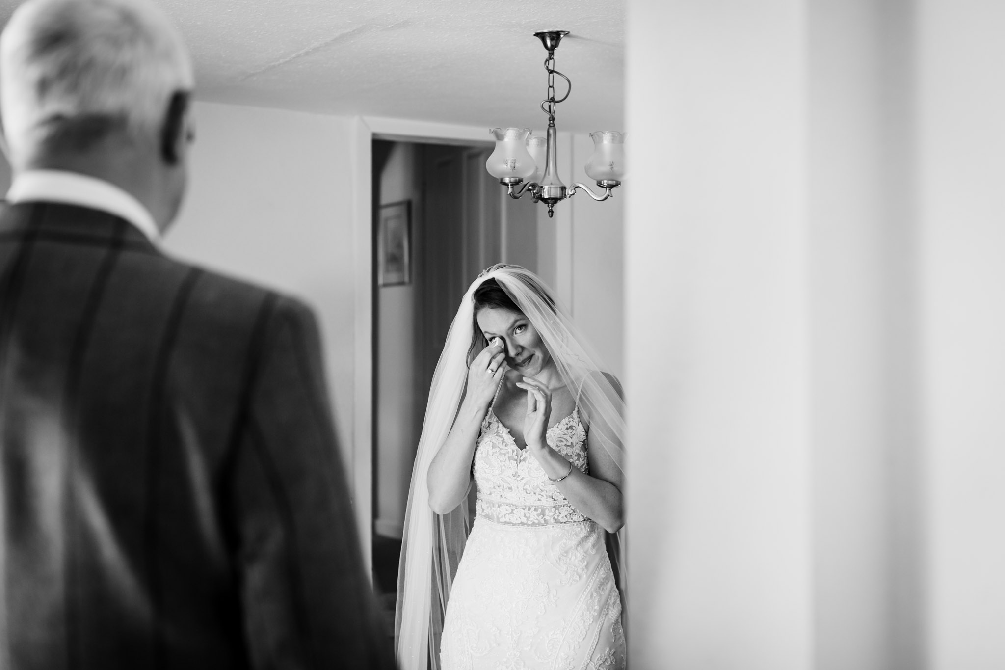 bride wiping away her tears when she sees her dad crediton wedding