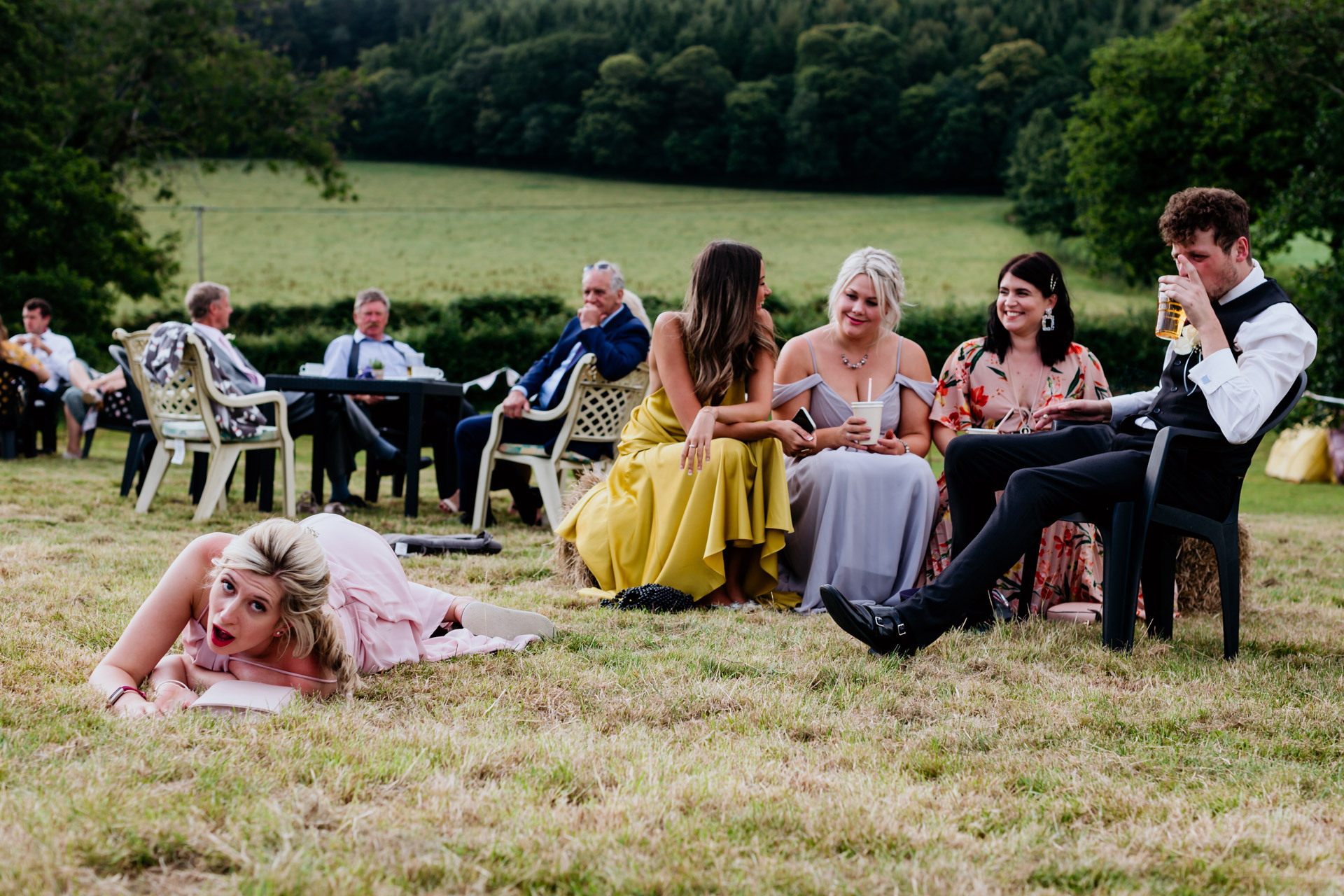 drubk bridesmaid lying on the grass devon marquee wedding