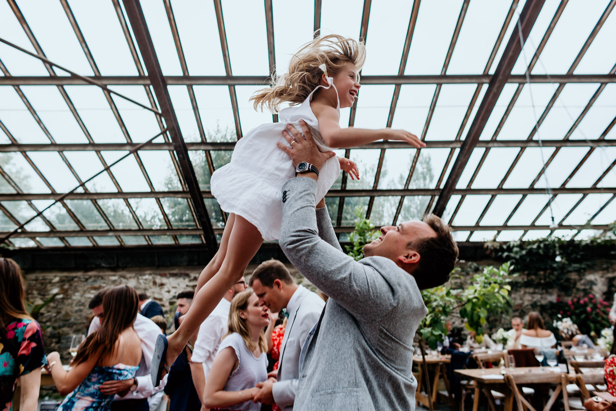 guest throws little girl up in the air anran glasshouse wedding devon