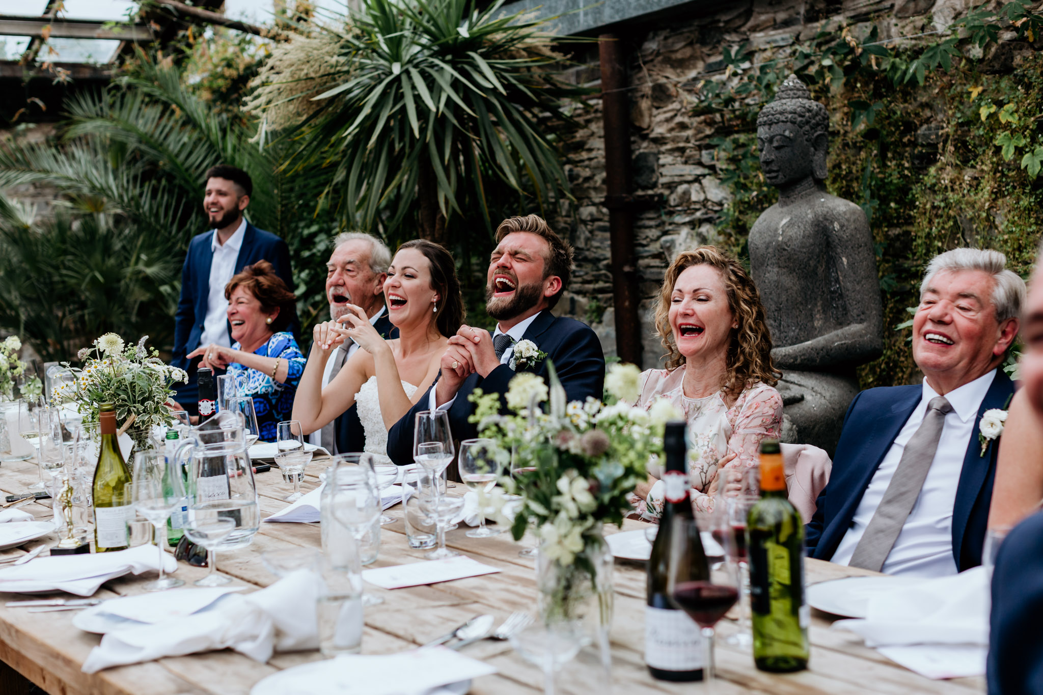 groom and top table laughing at the speeches at an anran devon wedding