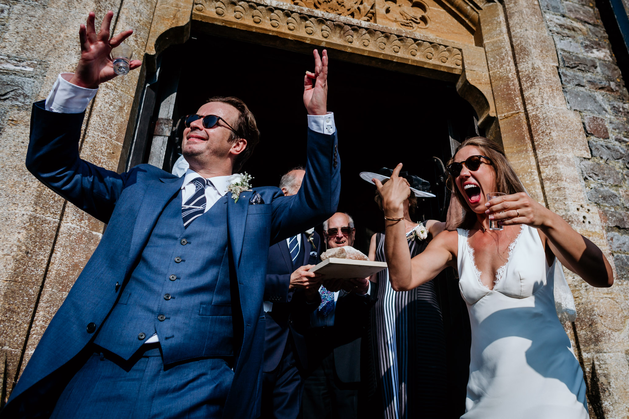 a bride and groom down shots in polish tradition at huntsham court wedding