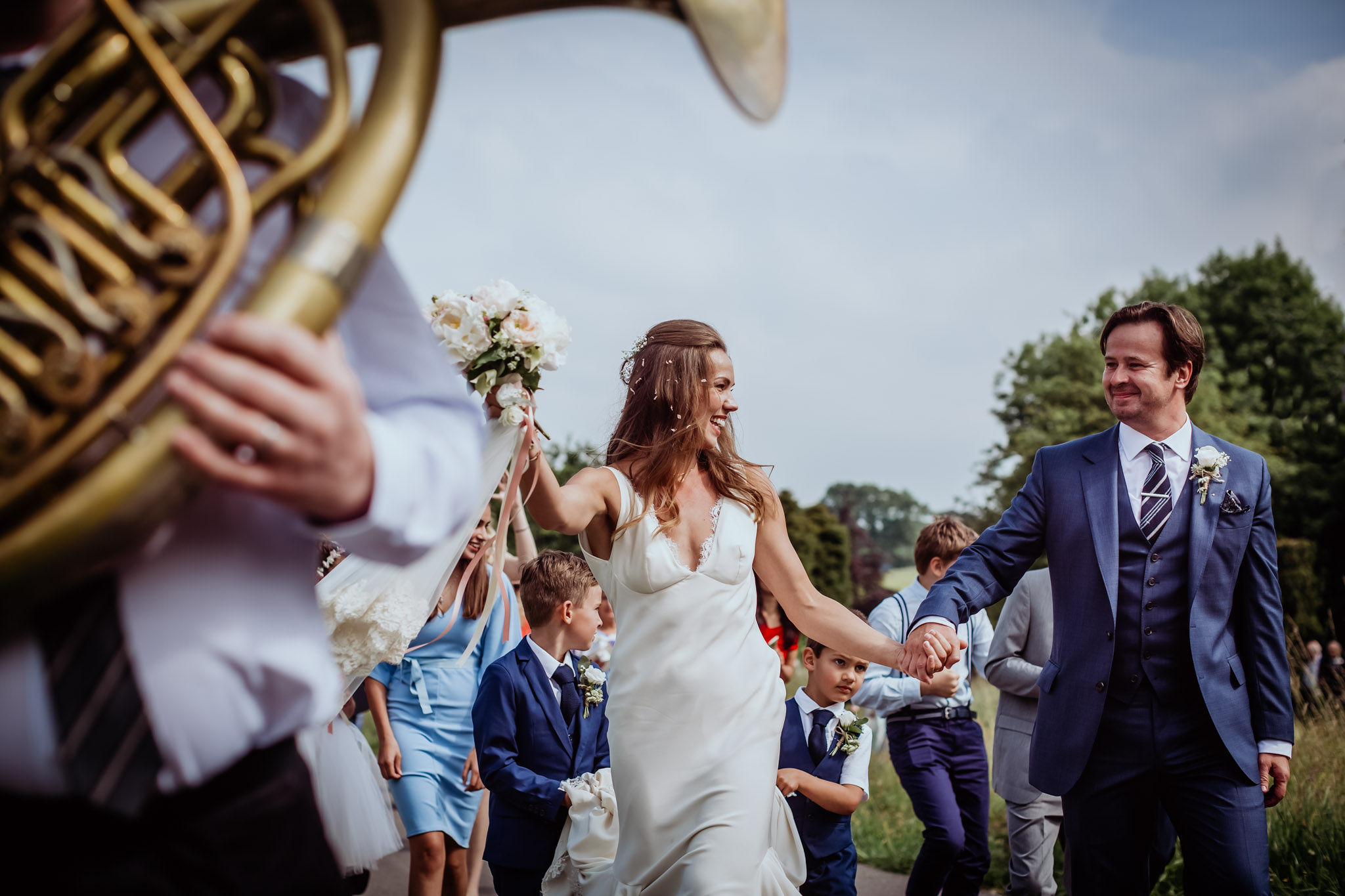 bride and groom dancing with great brass junkies band to lead them from church to reception