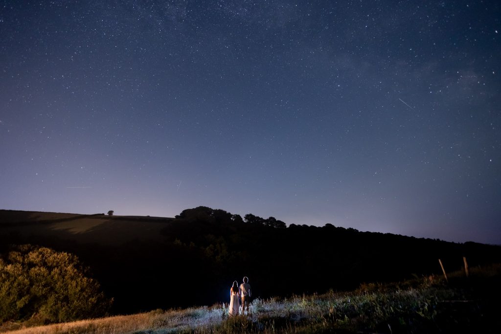 a couple under the night stars and shooting star at a devon wedding
