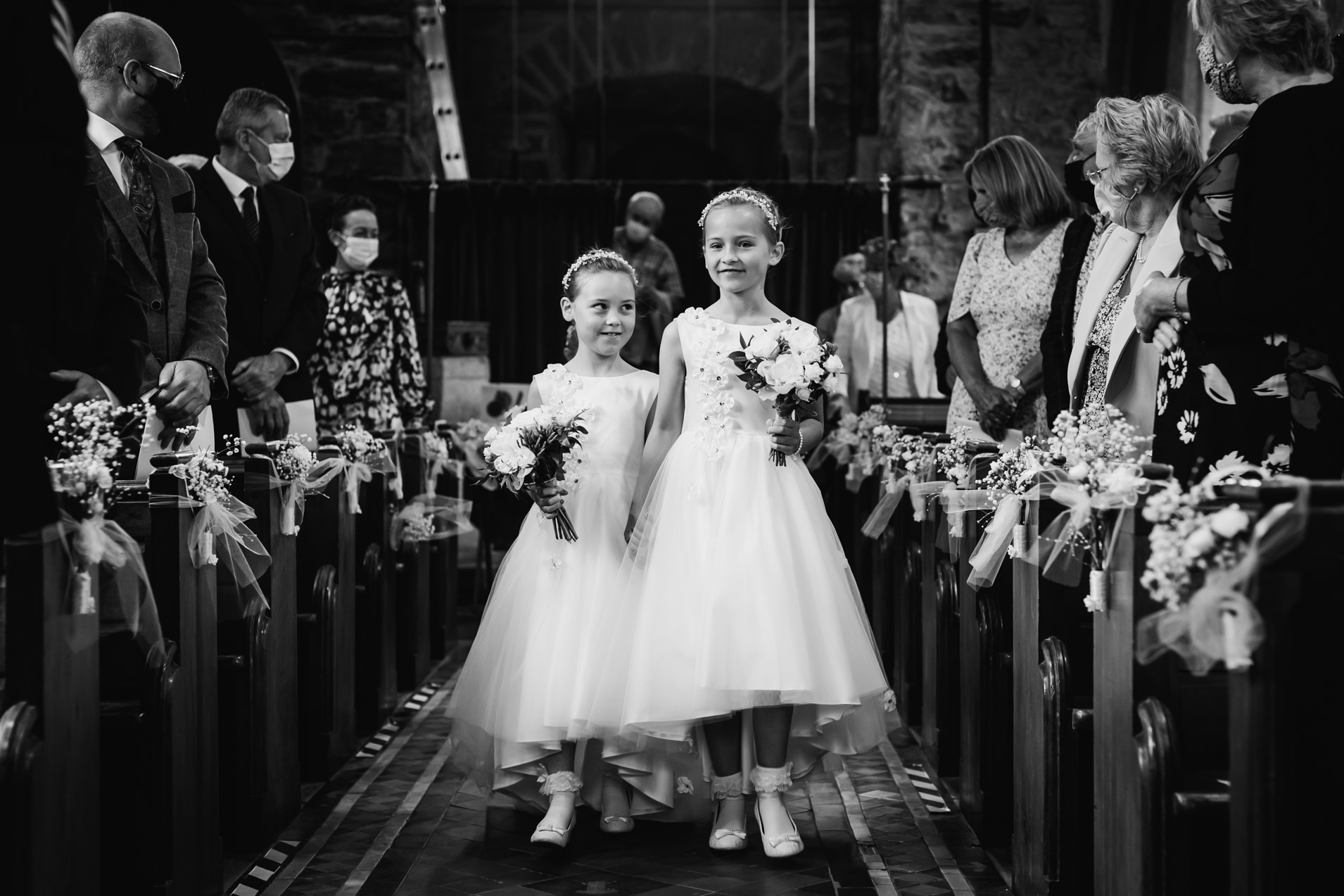portfolio image of flower girls walk down the aisle having a proud moment together at a devon village church wedding