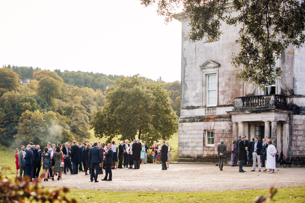 wedding guests outside sharpham house