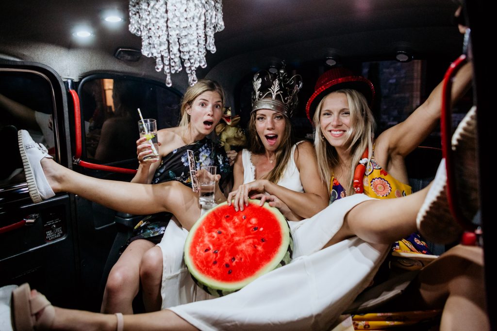 a bride and friends get wild in a taxi cab photobooth at huntsham court wedding