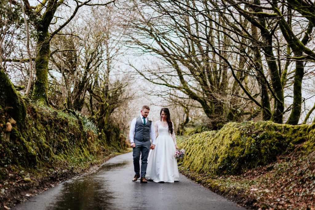 couple take a quiet walk on the driveway at trevenna barns