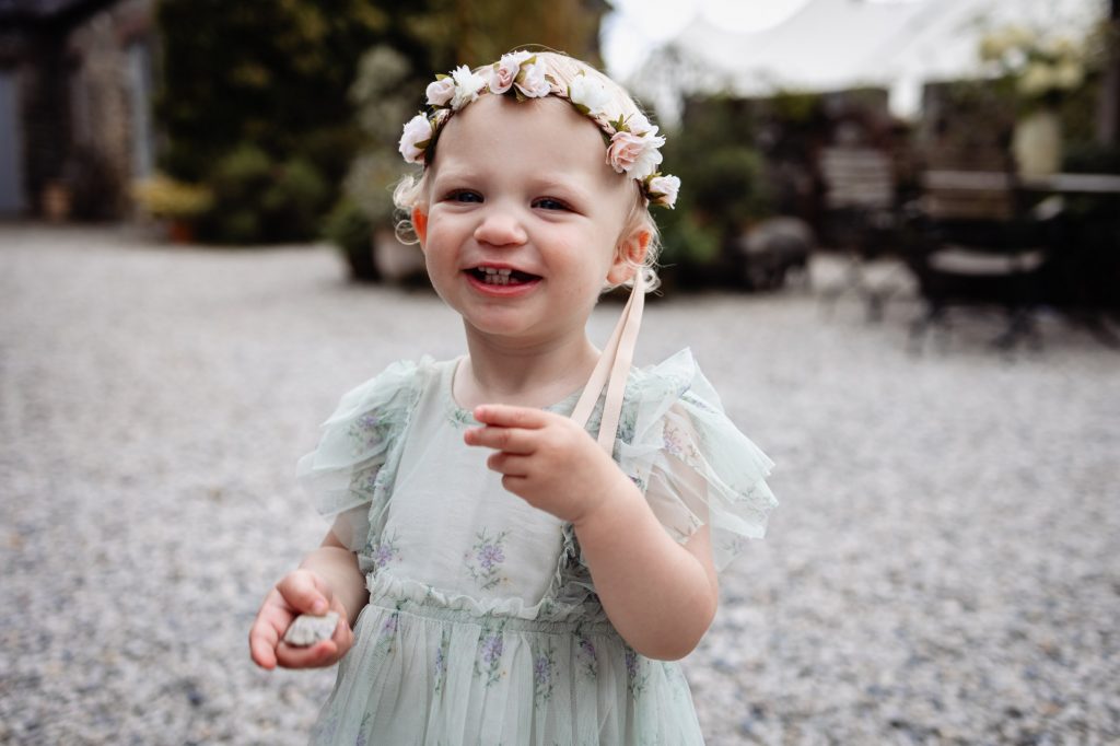 little flower girl smiles at wonwood barton devon wedding venue