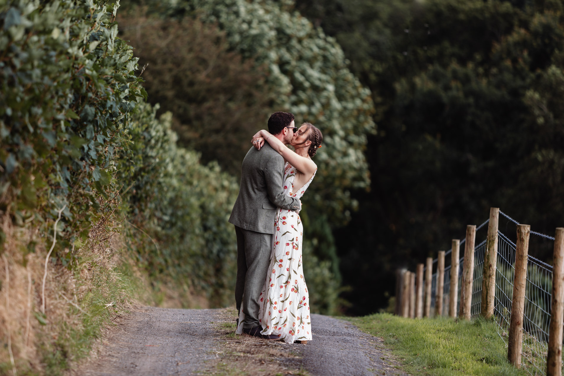 bride and groom embrace on driveway at wonwood barton relaxed wedding