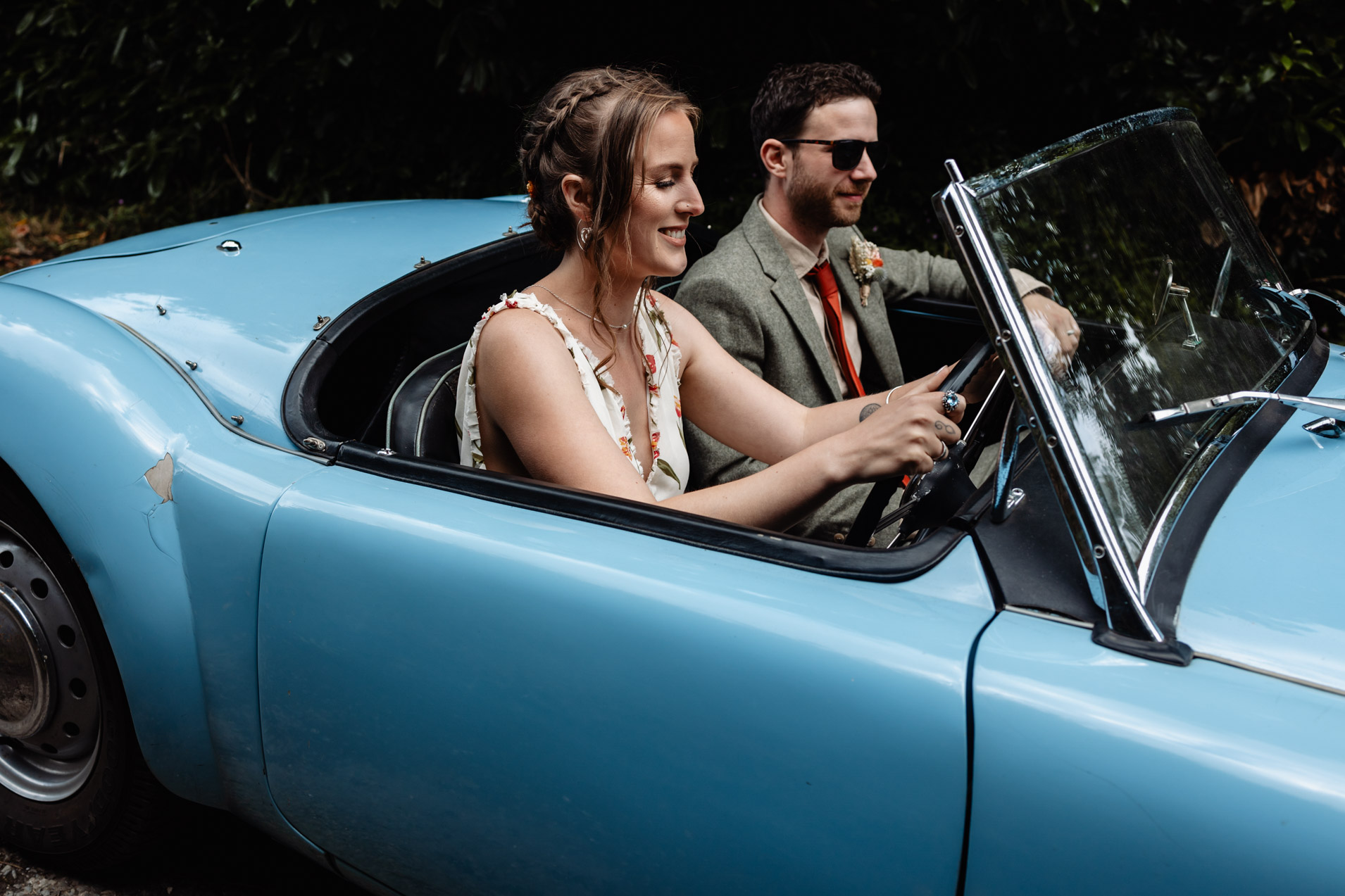 bride and groom in vintage MG car at wonwood barton wedding