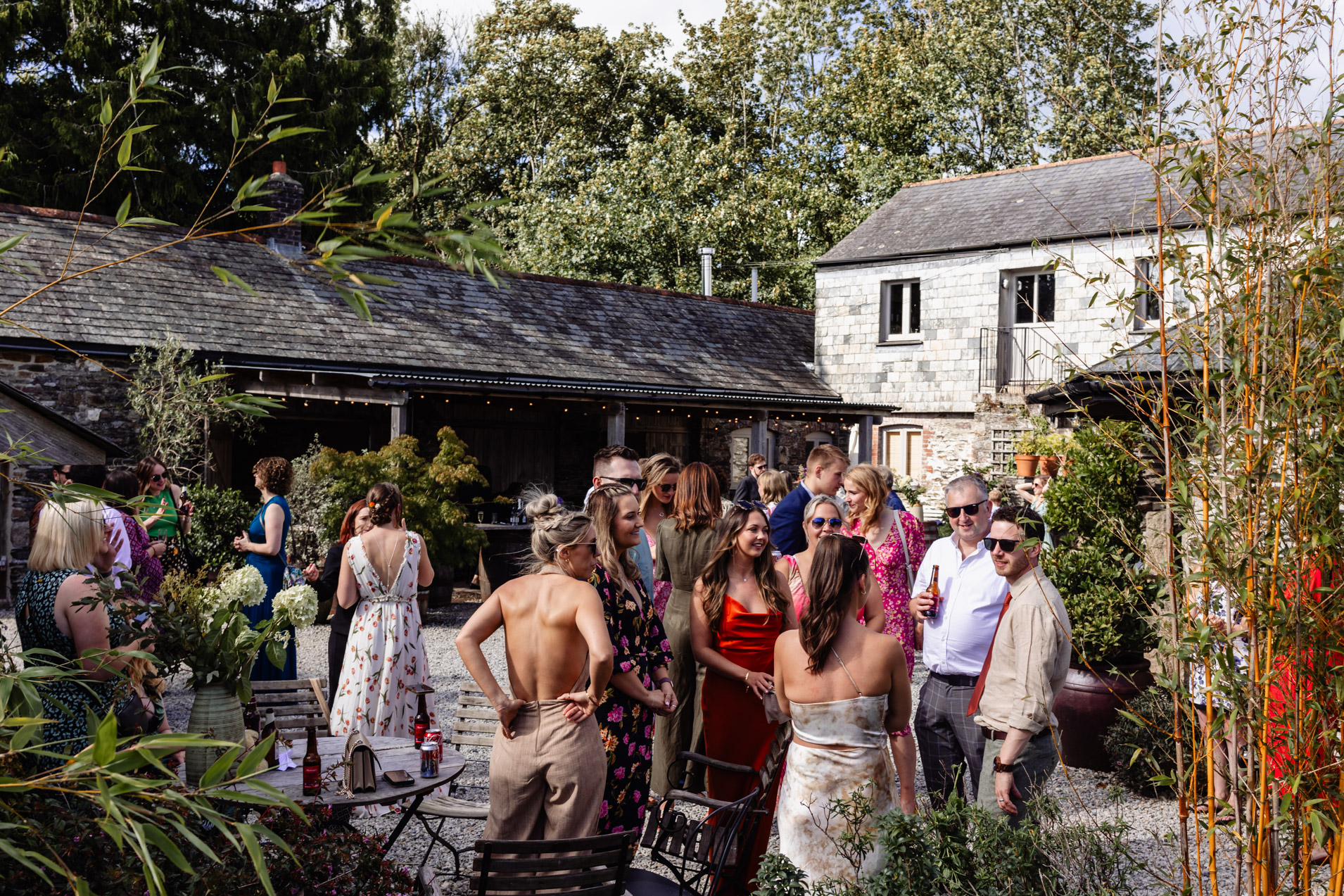 guests in the courtyard at wonwood barton wedding devon
