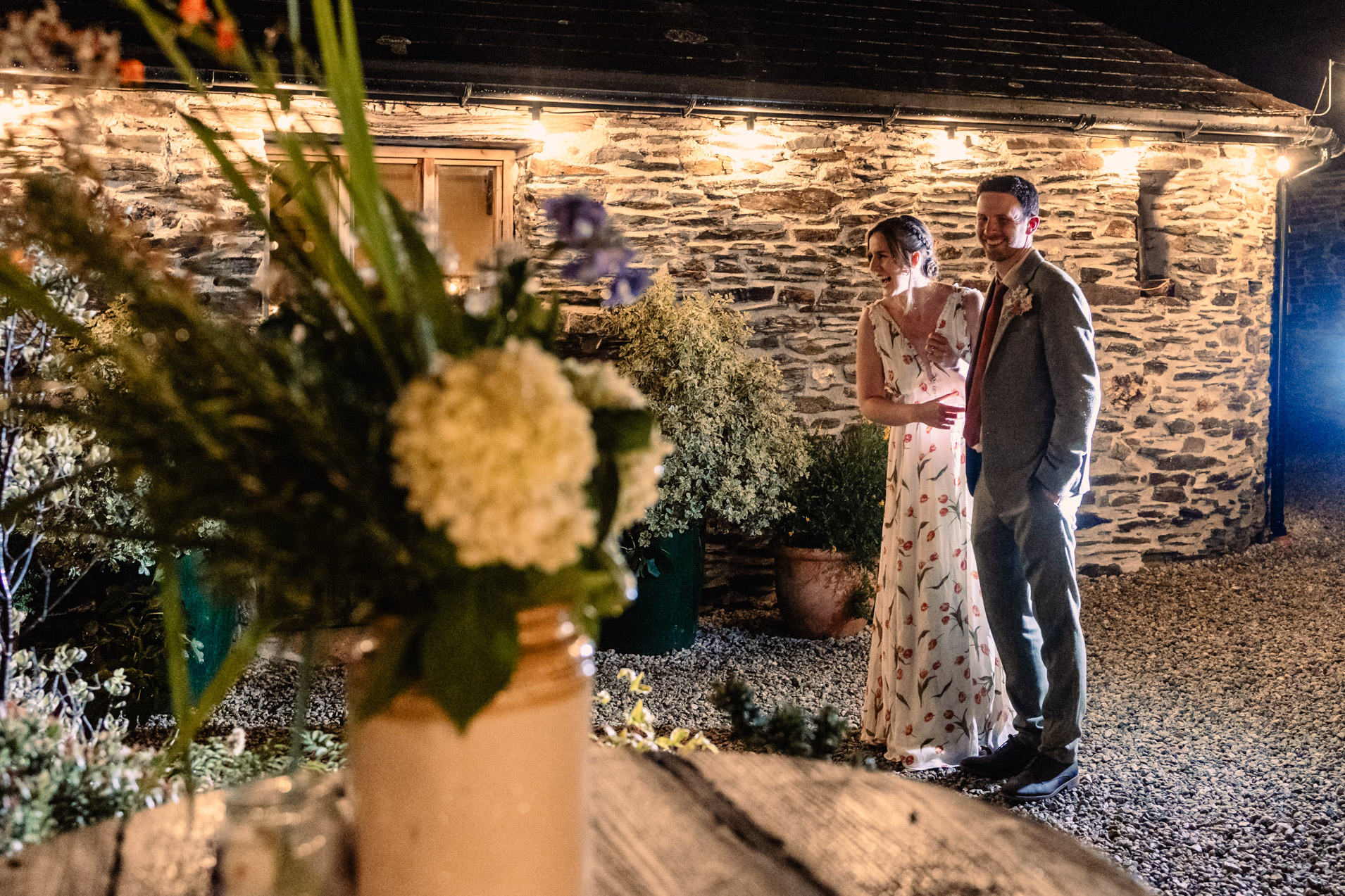 the couple enjoy themselves in the courtyard at night at wonwood barton