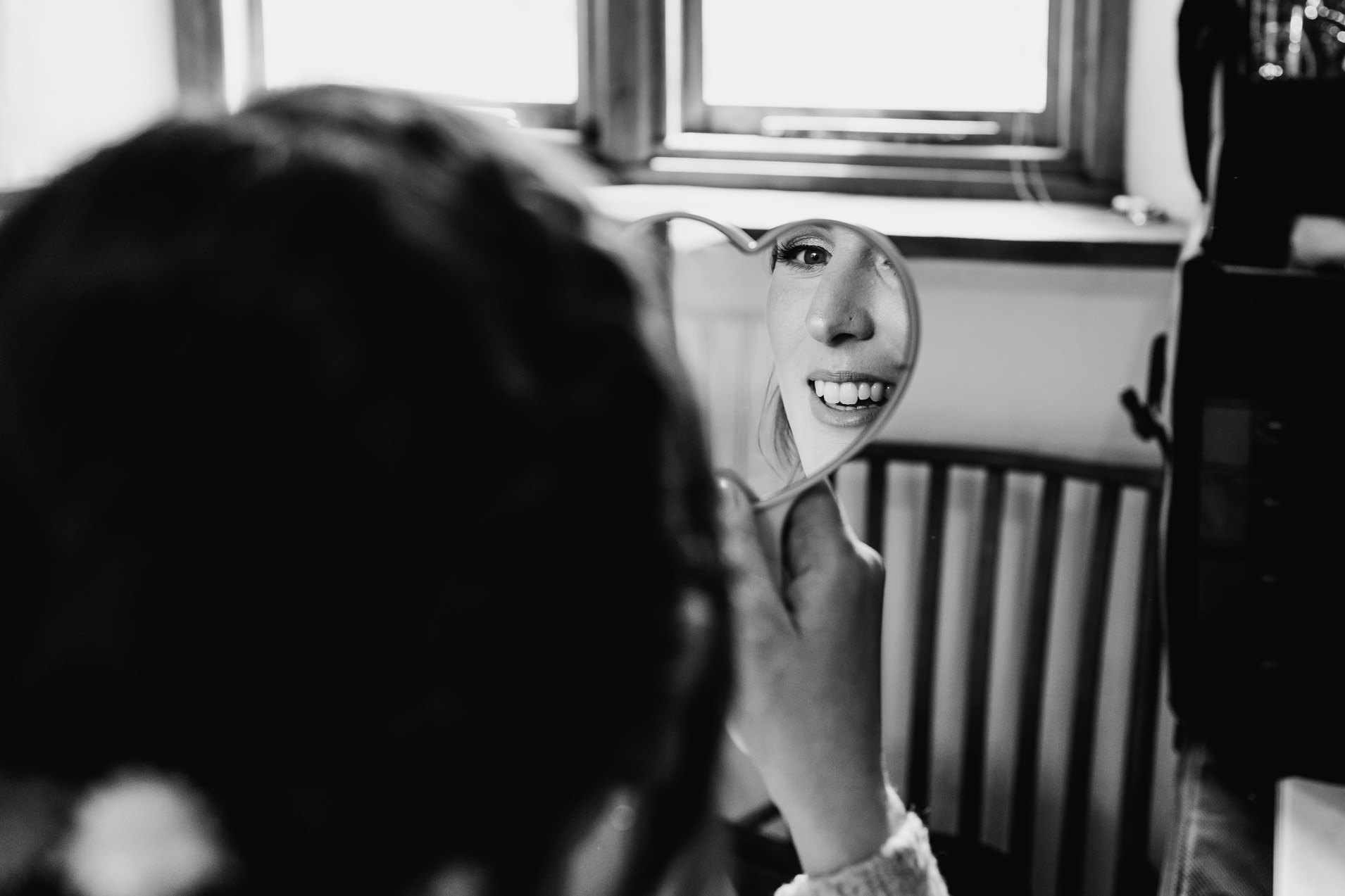 brides face reflected in a mirror at wonwood barton wedding venue tavistock