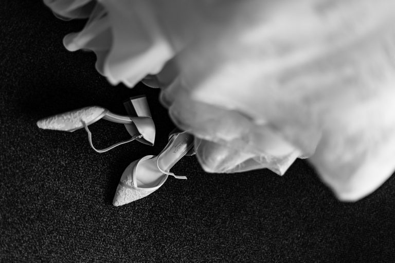 shoes below the wedding dress in black and white