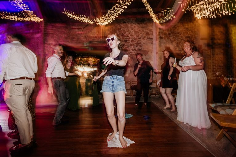 a bridemaid mops a drink up by dancing around on a cloth
