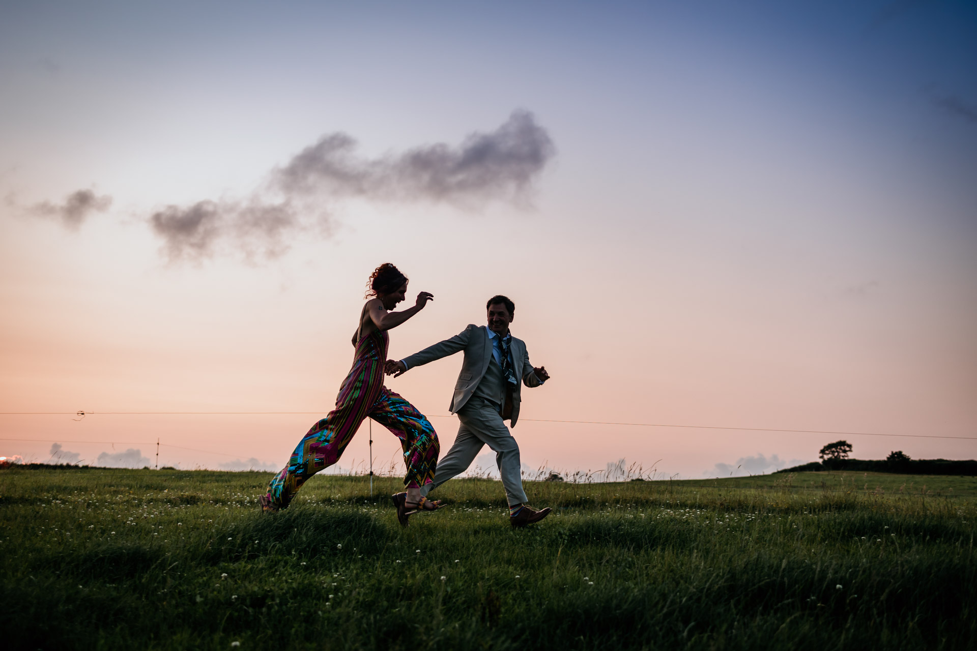 running across a field at sunset