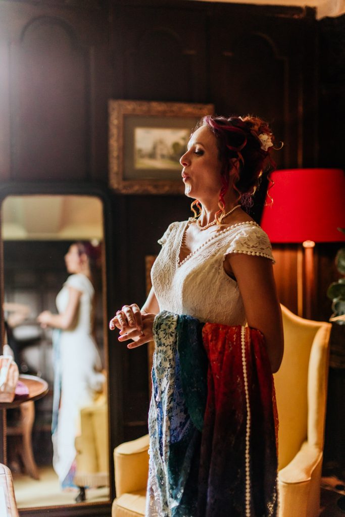 a bride takes a deep breath as she gets ready in the manor house at bradstone manor