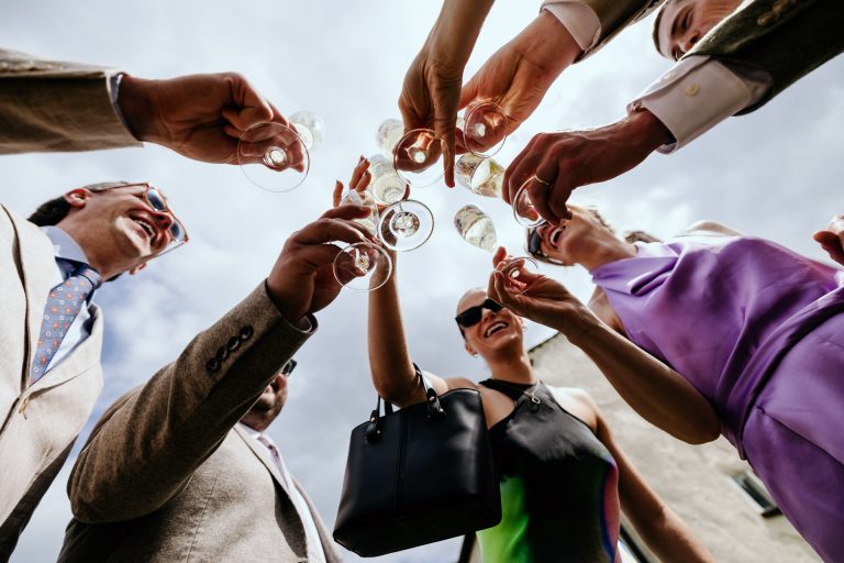 glasses are brought together for a cheers