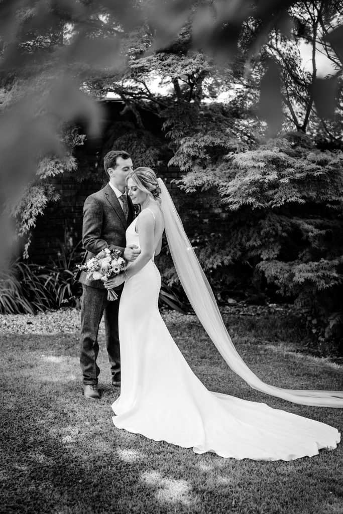 a groom and an elegant bride with long veil at upton barns