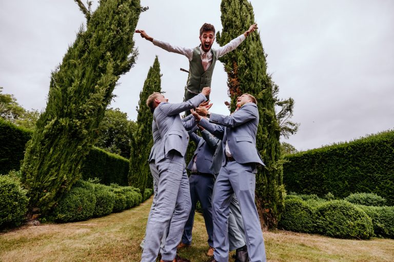 the groom is lifted into the air