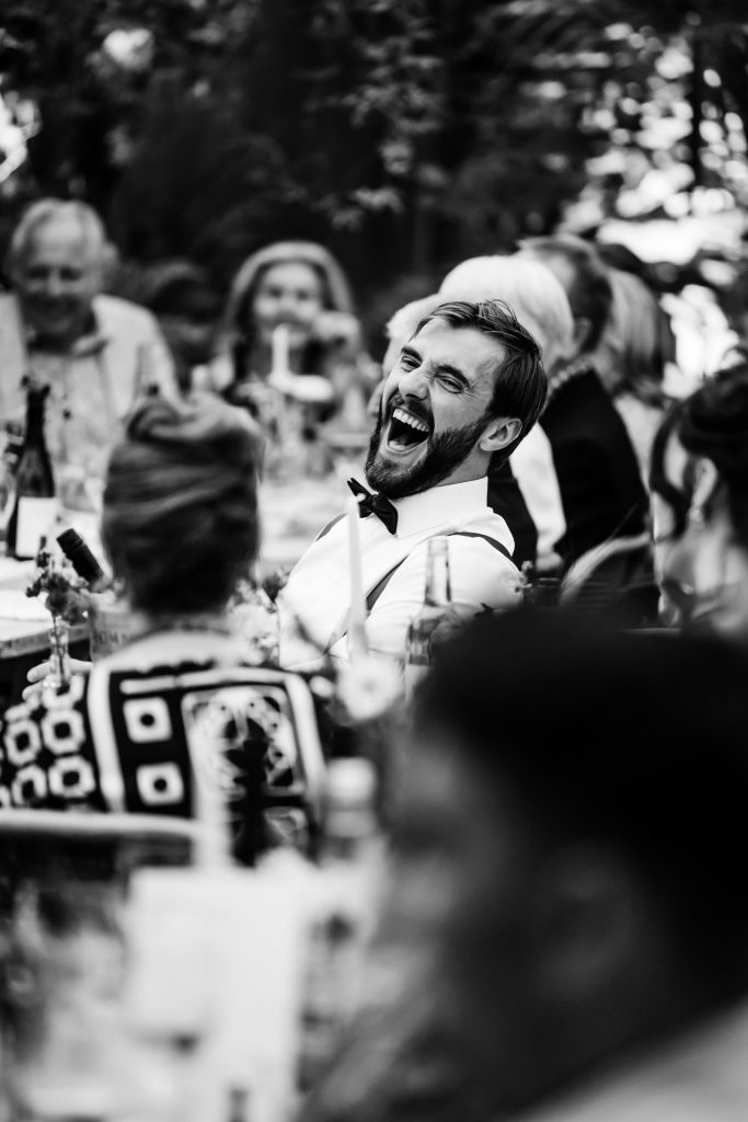 agroom with a fantastic big laugh in the glass house at anran during speeches