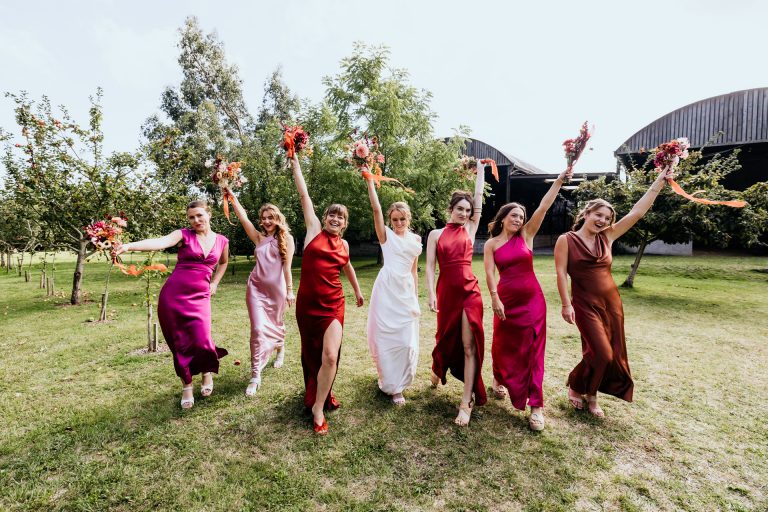 bridesmaids pose with their bouquets in the orchard at anran