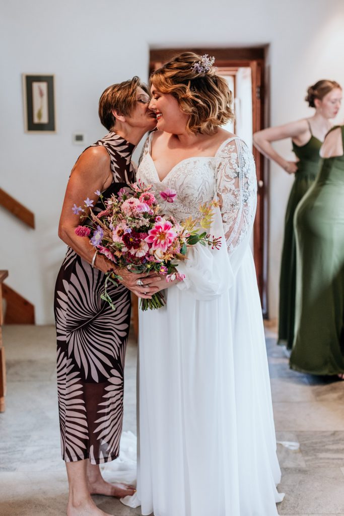 a mum embraces her daughter before her wedding ceremony
