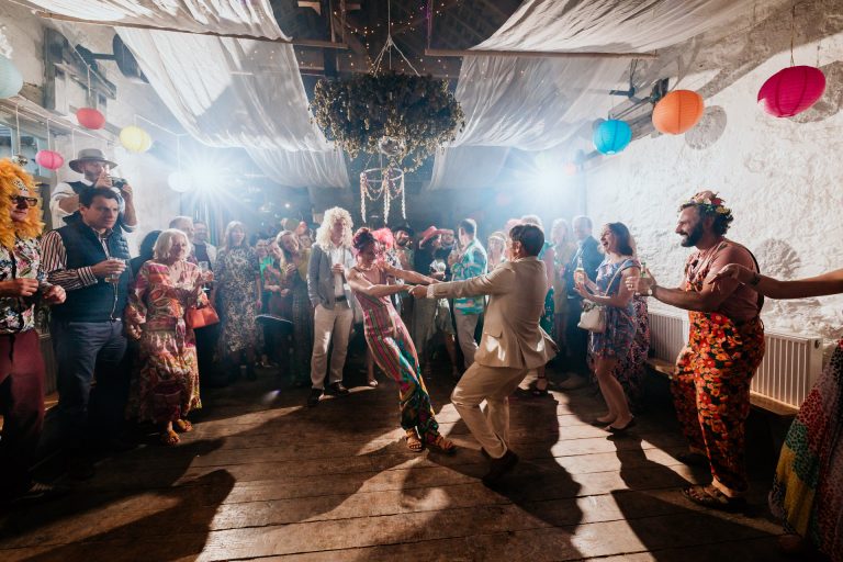 bride and groom spin on the dancefloor at colourful bradstone manor wedding