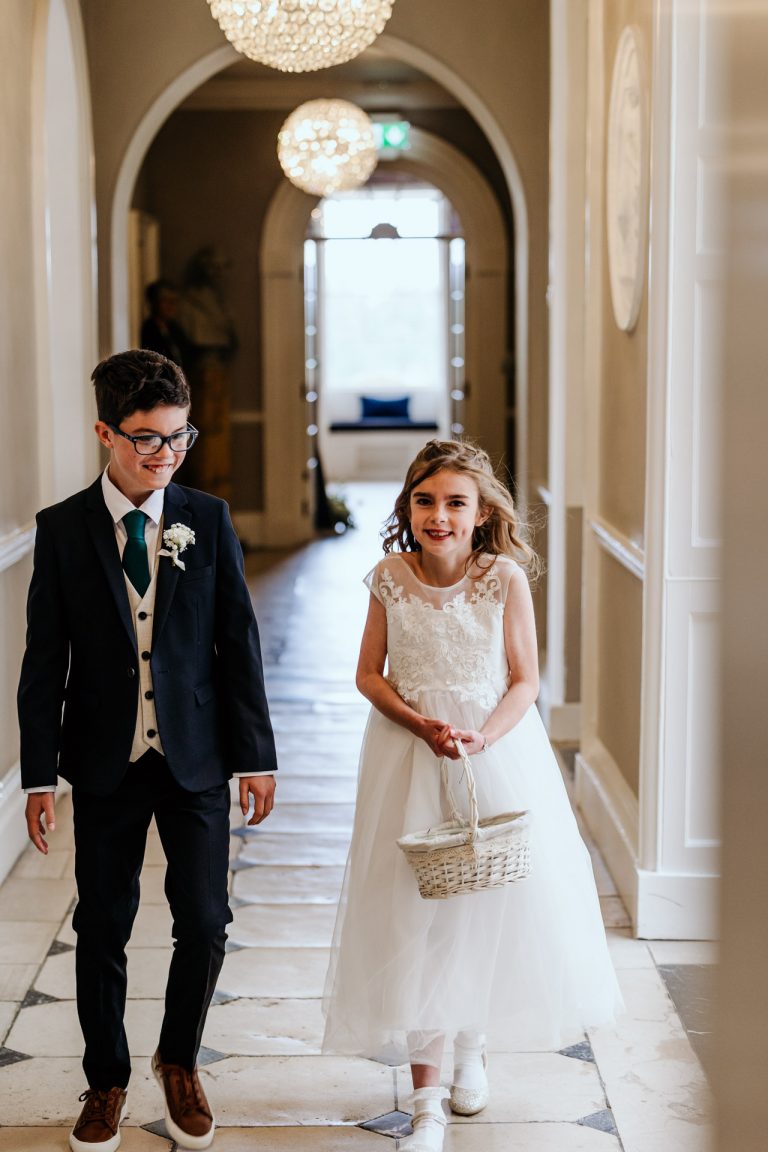 brother and sister make cute paige boy and flower girl for their parents wedding at rockbeare