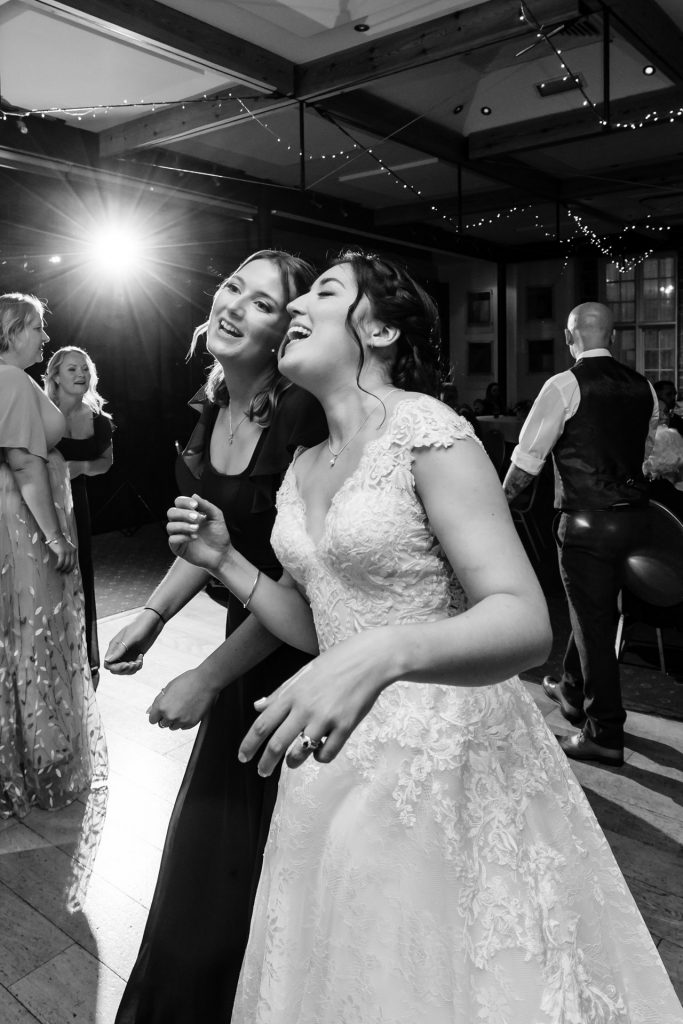 the bride sings and dances with her best friend and bridesmaid at a wedding at the bedford hotel in tavistock