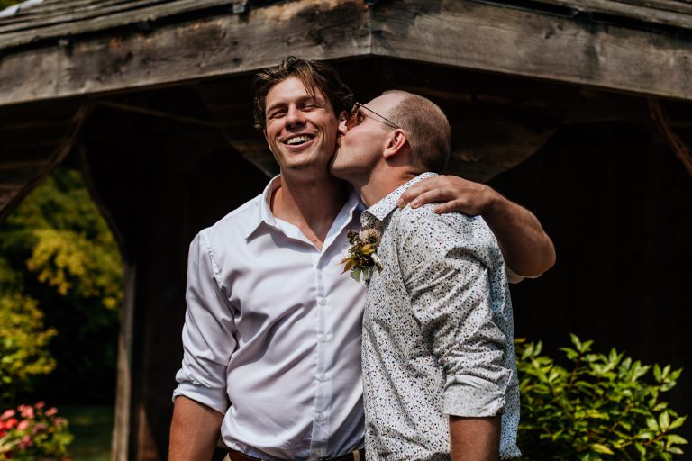 the brides brothers have a hug and kiss