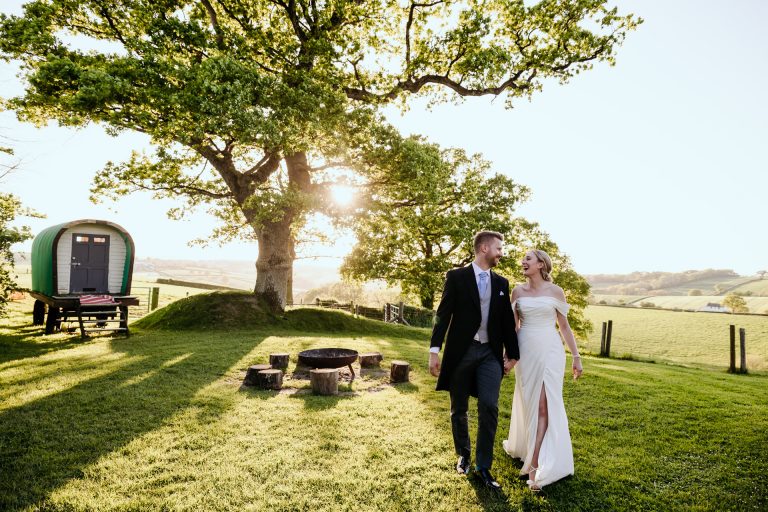 bride and groom with sunlight coming through the trees at Higher Eggbeer.