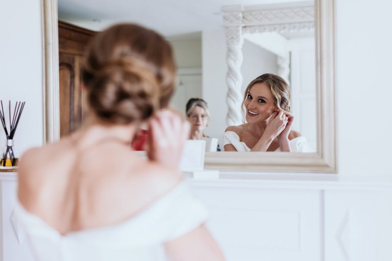 bride puts her earrings on at anran