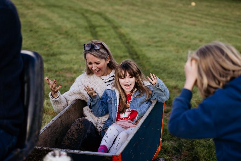 a family gets sprayed by mud in the ride on trailer