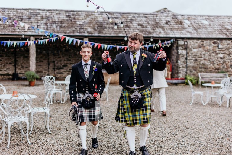 getting the drinks in, two groomsmen in kilts