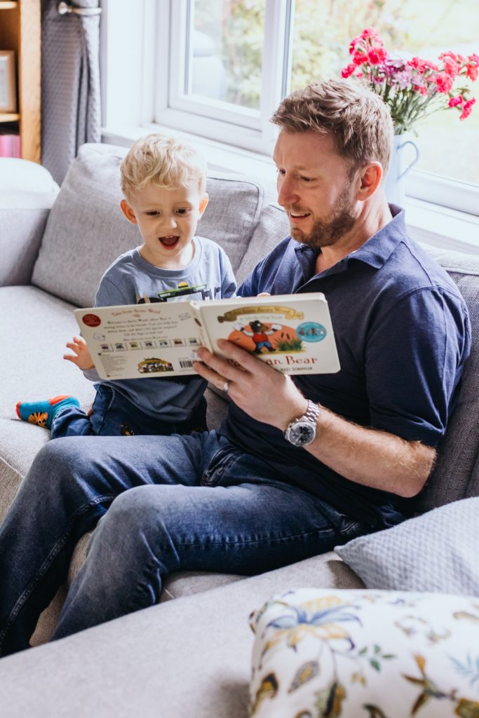 a father reads to his son