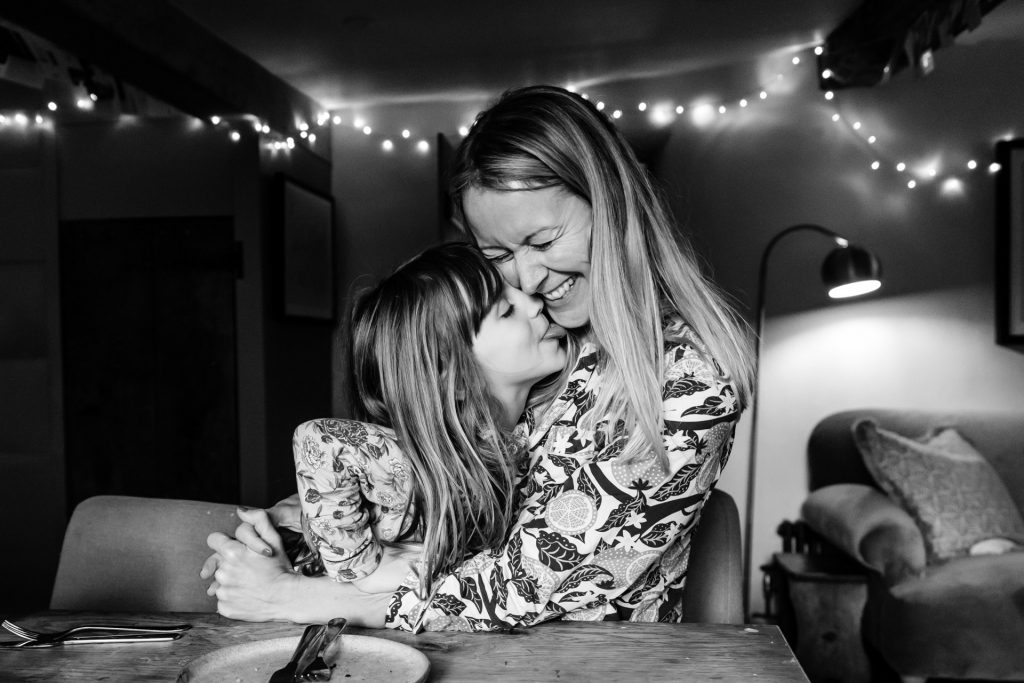 mum and daughter cuddle during a day in the life family photography session in devon