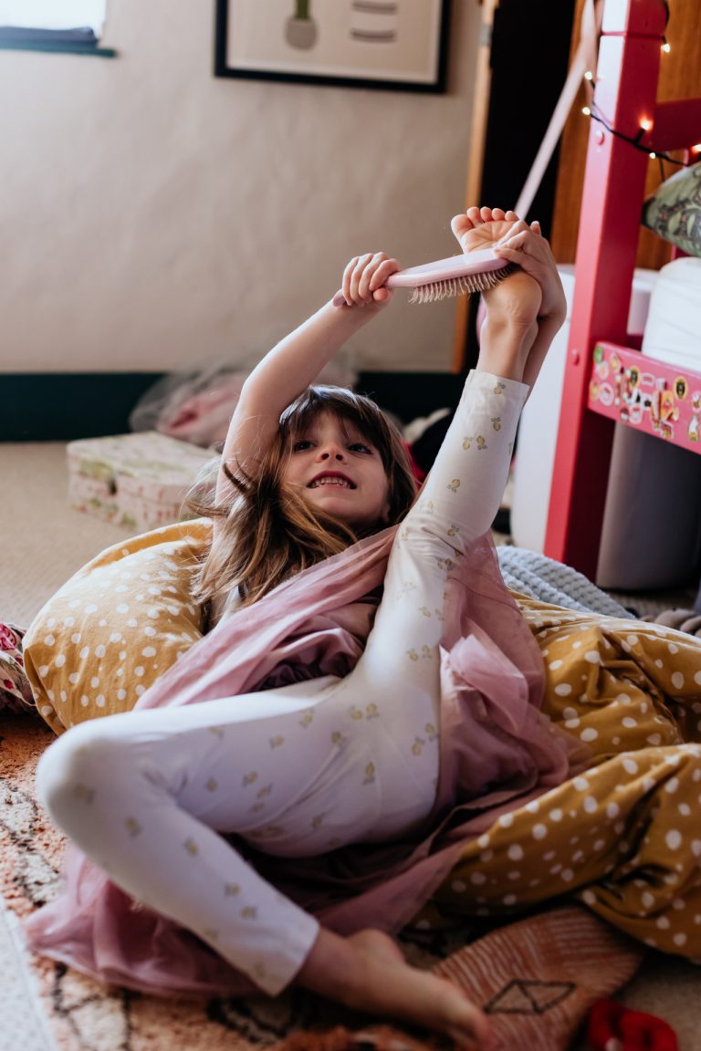 a girl wrestles with her hairbrush