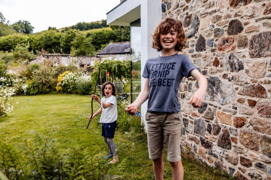two boys playing by their pond in the garden