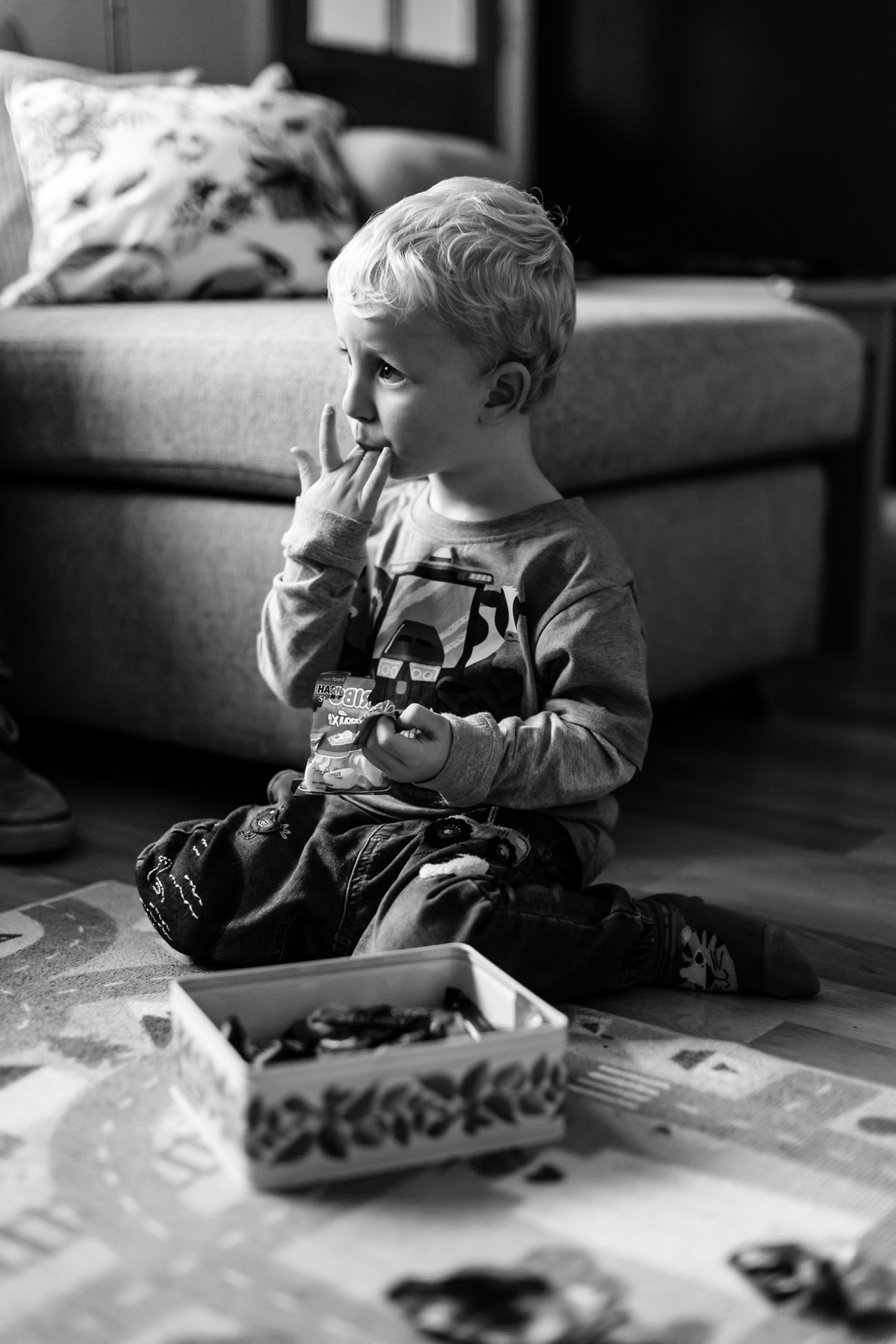 two year old eating sweets and licking fingers